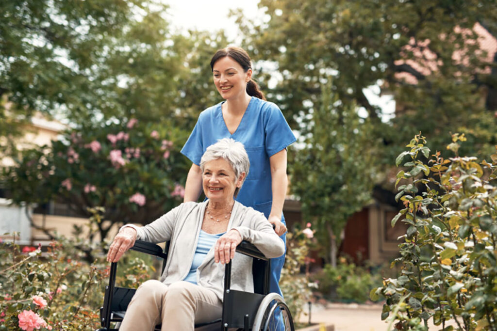 Shot of a senior woman in a wheelchair out for fresh air in the garden with her caregiver