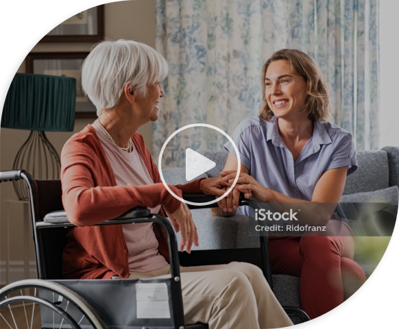 A video of an older woman in a wheelchair conversing with another woman.