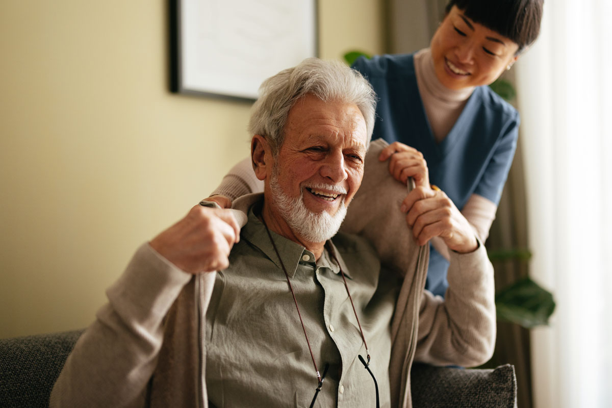 nurse assisting elderly man