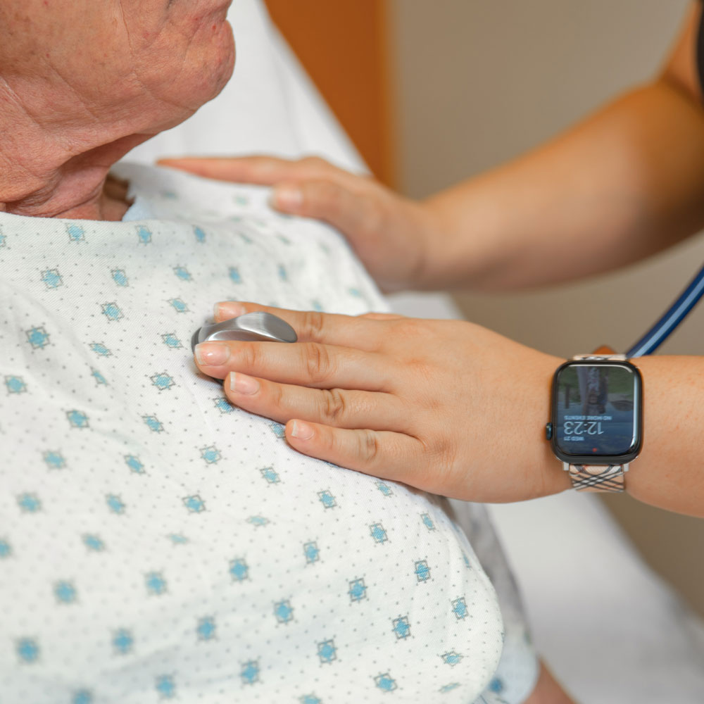 nurse checking heart of patient