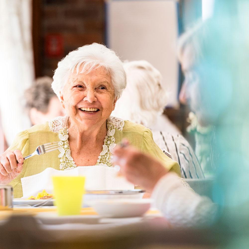 elderly woman enjoying a meal