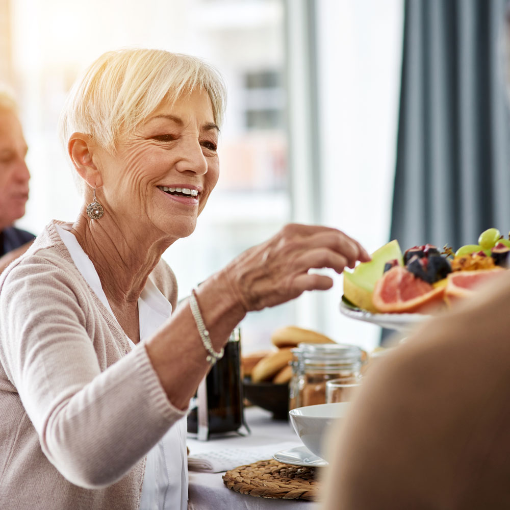 woman eating fruit platter