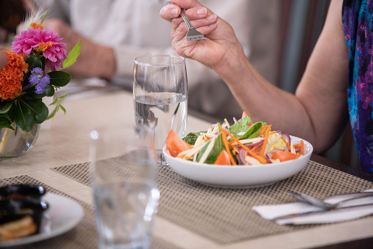 Resident eating a salad