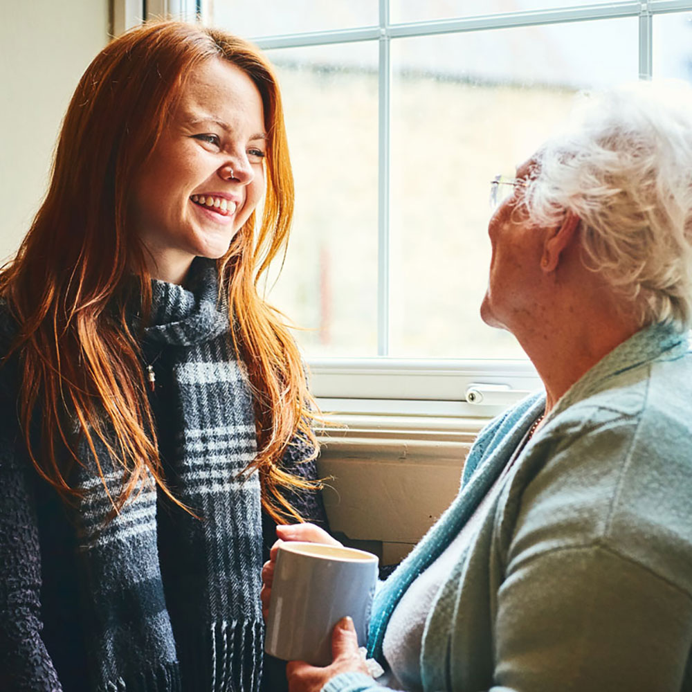 elderly woman & younger woman chatting