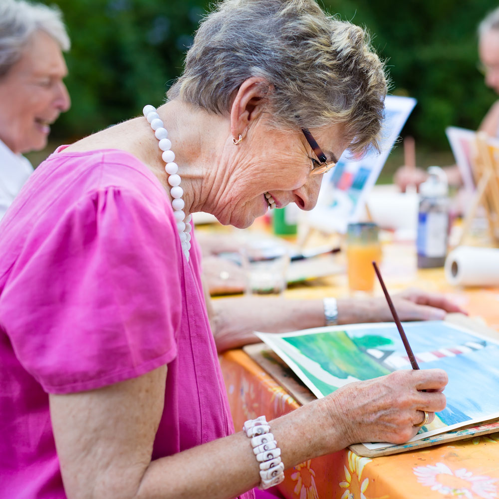 adults painting outside