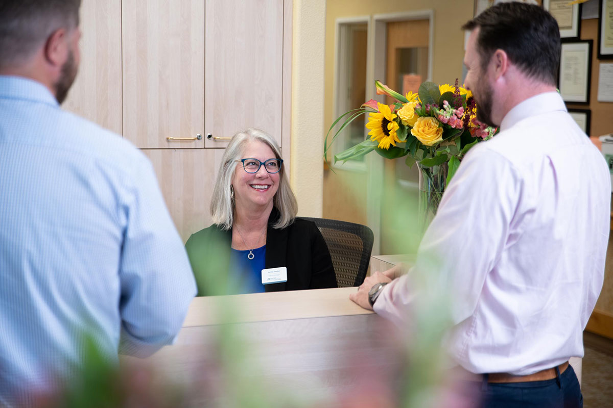 Northwoods Lodge staff member helping a client with paperwork